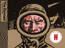 Load image into Gallery viewer, The cover to The Eternaut, featuring a man's face from the nose up. He appears to be scowling at the viewer from inside a safety suit's goggles. Behind him is a city scene covered in snow with a meteor streaking overhead.
