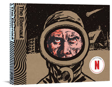 Load image into Gallery viewer, The cover to The Eternaut, featuring a man's face from the nose up. He appears to be scowling at the viewer from inside a safety suit's goggles. Behind him is a city scene covered in snow with a meteor streaking overhead.