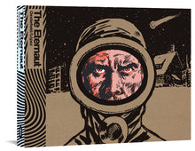 Load image into Gallery viewer, The cover to The Eternaut, featuring a man's face from the nose up. He appears to be scowling at the viewer from inside a safety suit's goggles. Behind him is a city scene covered in snow with a meteor streaking overhead.