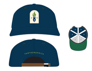 Several mockup images of the Fantagraphics x Ebbets hat. The first features a frontal view, with the hat and brim in blue, and a cream tombstone shape featuring the Fantagraphics logo: a blue pen nib with a green torch flame above it and one green ink drops on either side. The second features the back of the hat, which is blue with the word "Fantagraphics" in green embroidery above the brown leather adjustment band. The third view is from underneath, showing the green color under the brim.